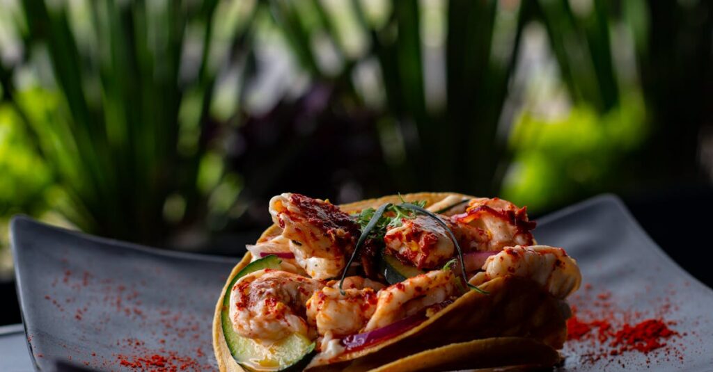 Delightful shrimp tacos with spices served on a black plate, showcasing Mexican cuisine.